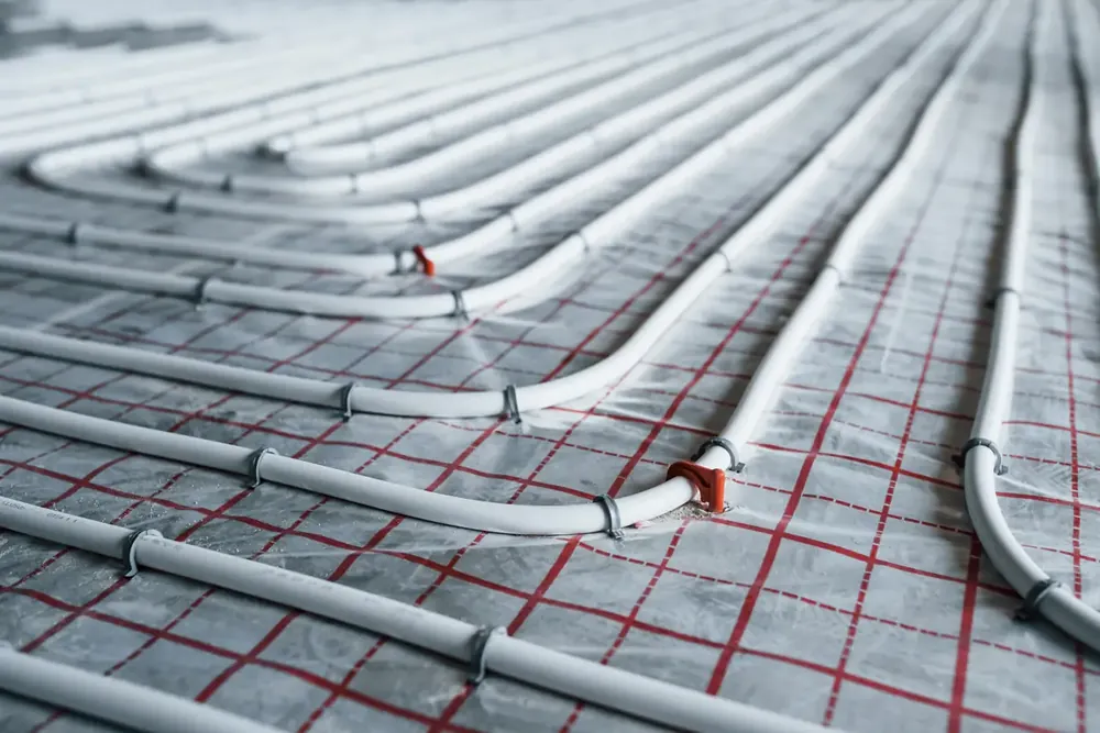 Hydronic pipe laid in loops across a floor on a printed grid underlay