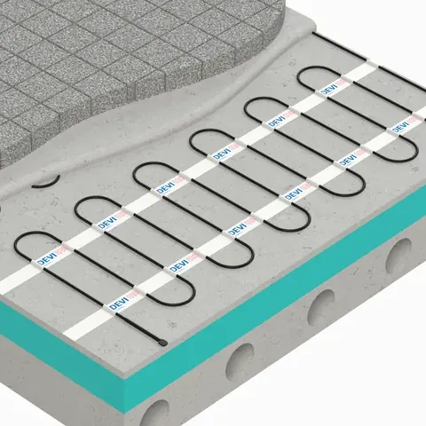 Cutaway of a concrete slab showing heating cable on fixing strips over insulation